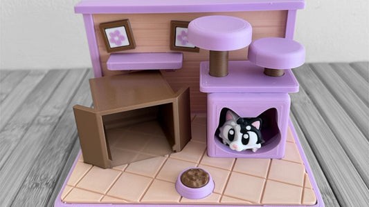 Pet playhouse with furniture and a small pet figure on a wooden floor.